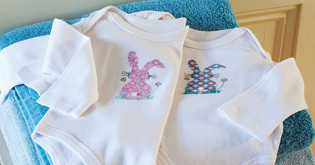 Cross-stitch bunny baby-grow