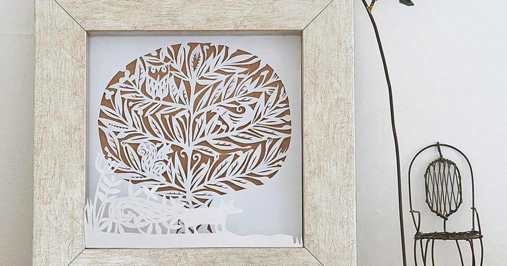 Paper-cut winter woodland scene